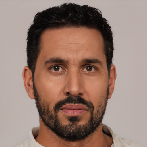 Neutral latino adult male with short  black hair and brown eyes