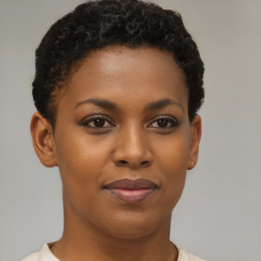 Joyful black young-adult female with short  brown hair and brown eyes