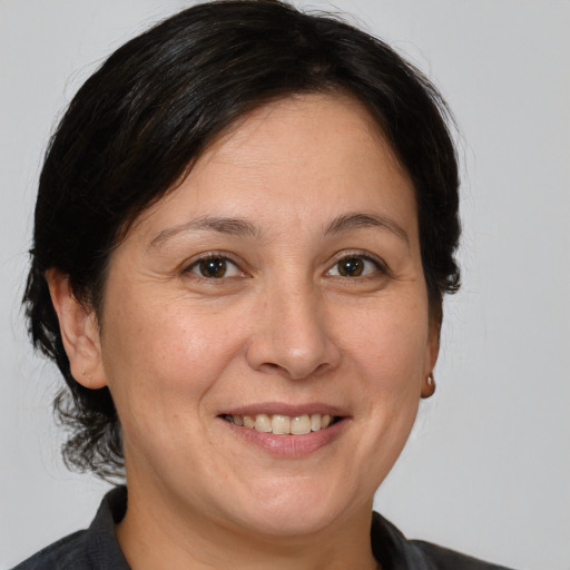 Joyful white adult female with medium  brown hair and brown eyes