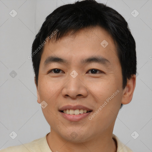 Joyful asian young-adult male with short  brown hair and brown eyes