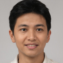 Joyful asian young-adult male with short  black hair and brown eyes