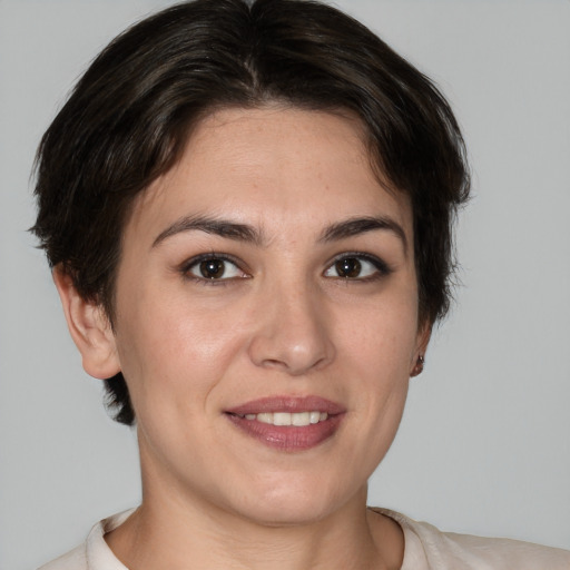 Joyful white young-adult female with medium  brown hair and brown eyes