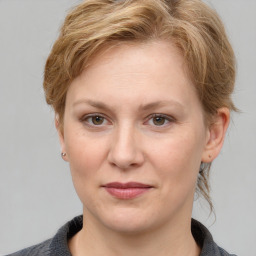 Joyful white adult female with medium  brown hair and grey eyes