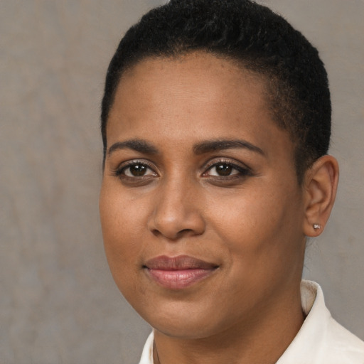 Joyful black young-adult female with short  brown hair and brown eyes