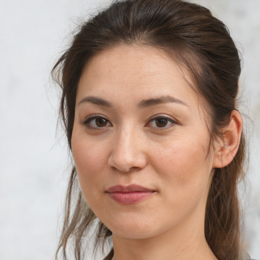 Joyful white adult female with long  brown hair and brown eyes