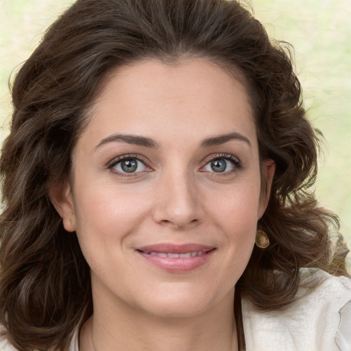 Joyful white young-adult female with medium  brown hair and green eyes