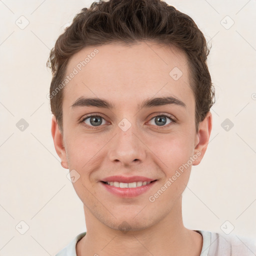 Joyful white young-adult male with short  brown hair and grey eyes