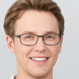 Joyful white adult male with short  brown hair and grey eyes