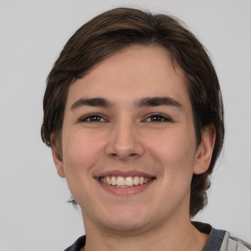 Joyful white young-adult male with medium  brown hair and brown eyes