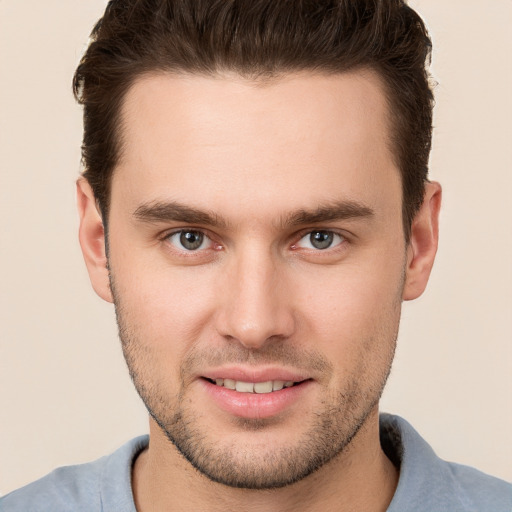 Joyful white young-adult male with short  brown hair and brown eyes