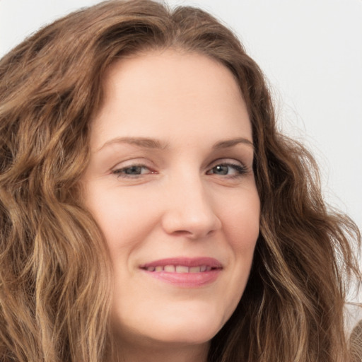 Joyful white young-adult female with long  brown hair and green eyes