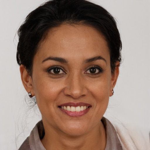 Joyful latino young-adult female with medium  brown hair and brown eyes