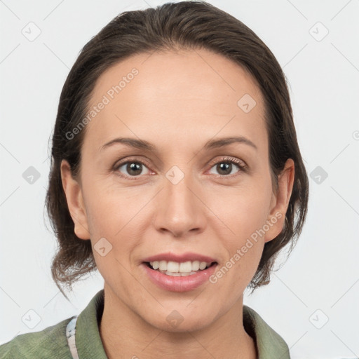 Joyful white adult female with medium  brown hair and grey eyes