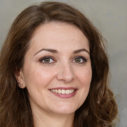 Joyful white young-adult female with long  brown hair and green eyes