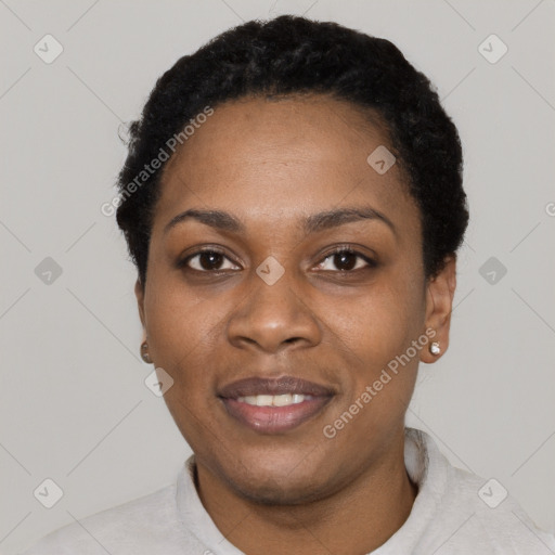 Joyful black young-adult female with short  black hair and brown eyes