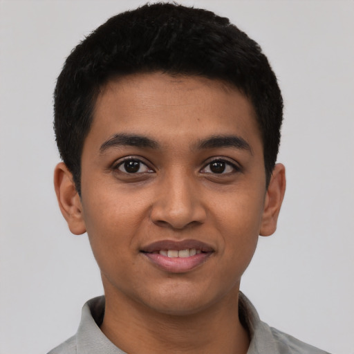 Joyful latino young-adult male with short  black hair and brown eyes