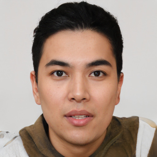 Joyful asian young-adult male with short  black hair and brown eyes