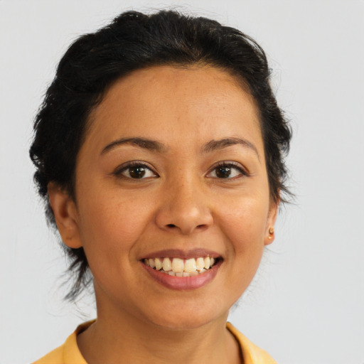 Joyful latino young-adult female with medium  brown hair and brown eyes