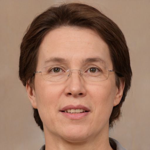 Joyful white adult female with medium  brown hair and green eyes