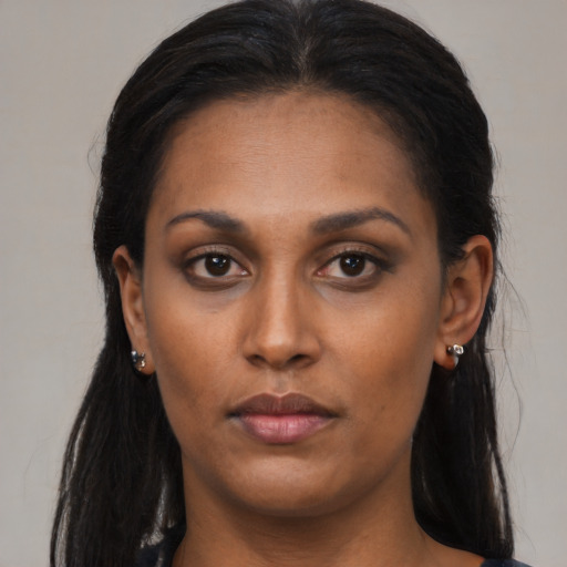 Neutral black young-adult female with long  brown hair and brown eyes
