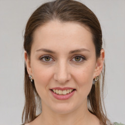 Joyful white young-adult female with medium  brown hair and grey eyes