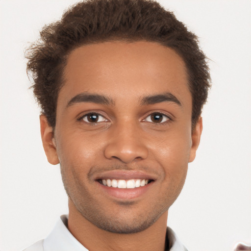 Joyful black young-adult male with short  brown hair and brown eyes