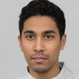 Neutral latino young-adult male with short  black hair and brown eyes