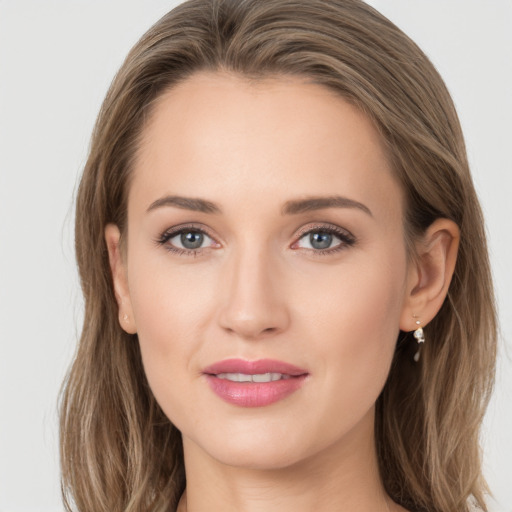 Joyful white young-adult female with long  brown hair and grey eyes