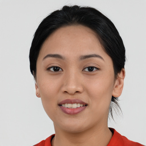 Joyful asian young-adult female with short  black hair and brown eyes