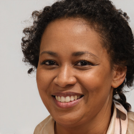 Joyful black young-adult female with medium  brown hair and brown eyes