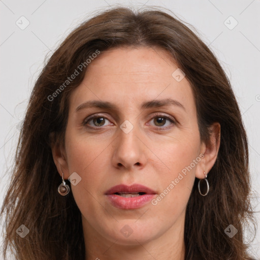 Joyful white adult female with long  brown hair and grey eyes