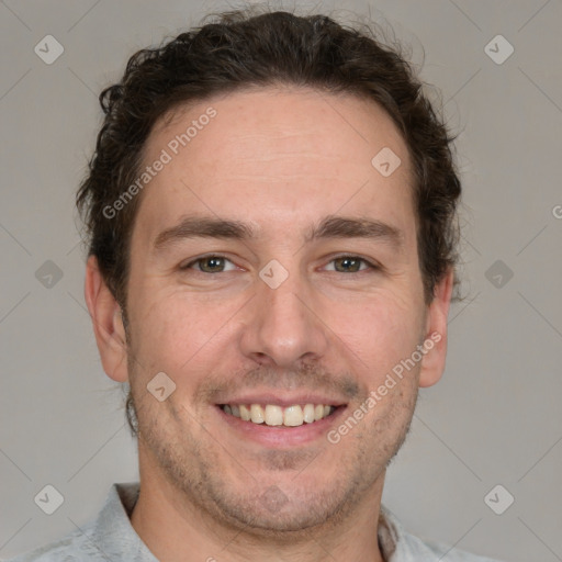 Joyful white adult male with short  brown hair and grey eyes