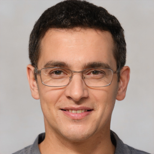 Joyful white adult male with short  brown hair and brown eyes