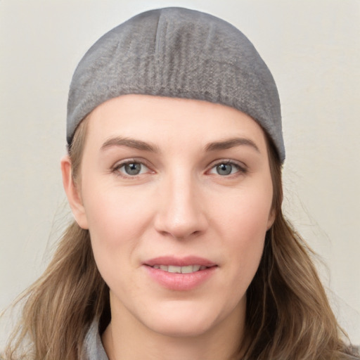 Joyful white young-adult female with long  brown hair and grey eyes