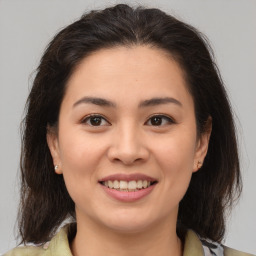 Joyful white young-adult female with medium  brown hair and brown eyes