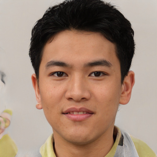 Joyful asian young-adult male with short  black hair and brown eyes