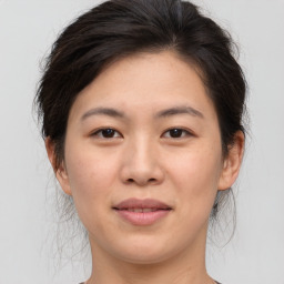 Joyful asian young-adult female with medium  brown hair and brown eyes