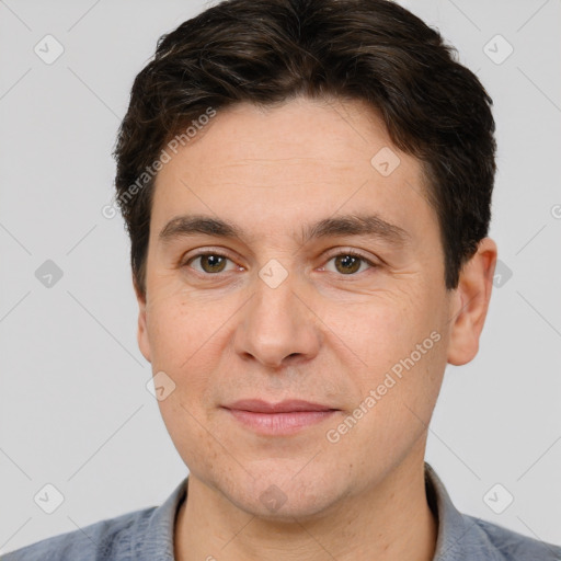 Joyful white adult male with short  brown hair and brown eyes