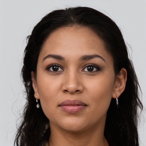 Joyful latino young-adult female with long  brown hair and brown eyes