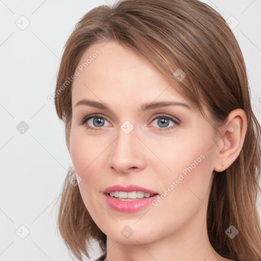 Joyful white young-adult female with long  brown hair and grey eyes