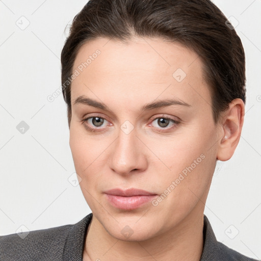 Joyful white young-adult female with short  brown hair and grey eyes