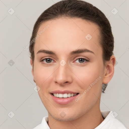 Joyful white young-adult female with short  brown hair and brown eyes