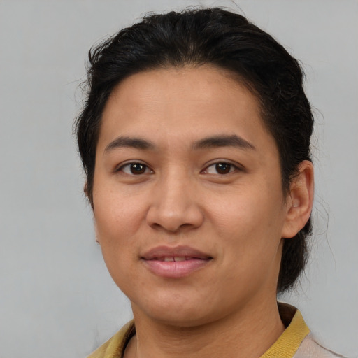 Joyful latino young-adult female with short  brown hair and brown eyes