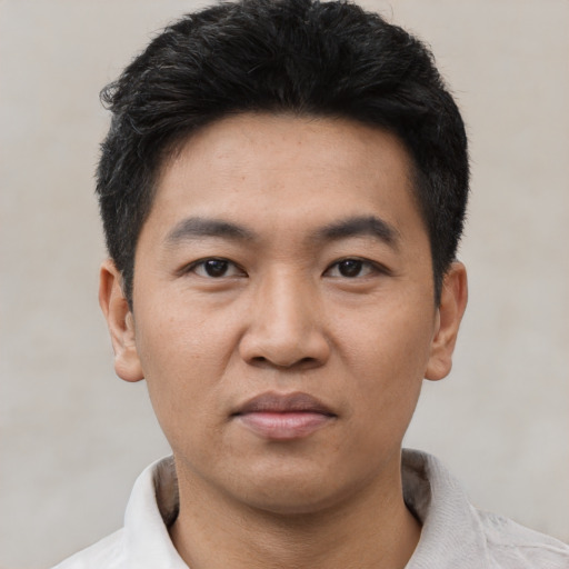 Joyful asian young-adult male with short  black hair and brown eyes