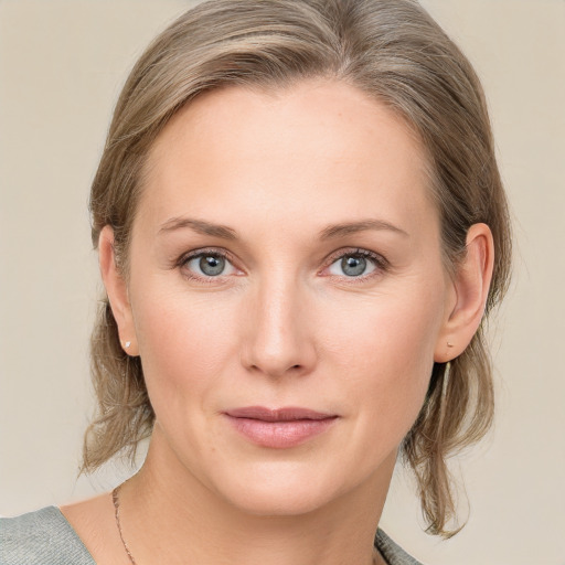 Joyful white young-adult female with medium  brown hair and blue eyes