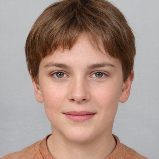 Joyful white child male with short  brown hair and grey eyes