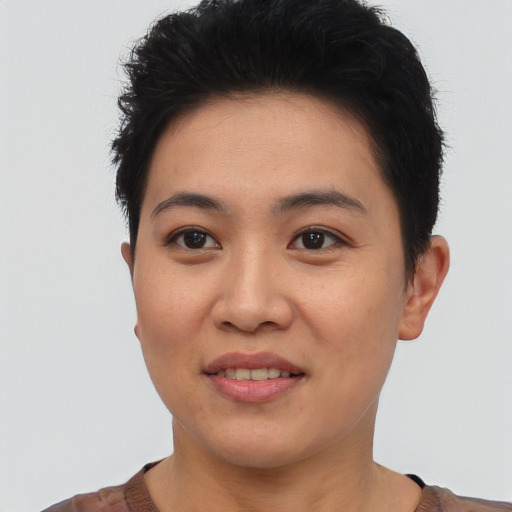 Joyful asian young-adult female with short  black hair and brown eyes