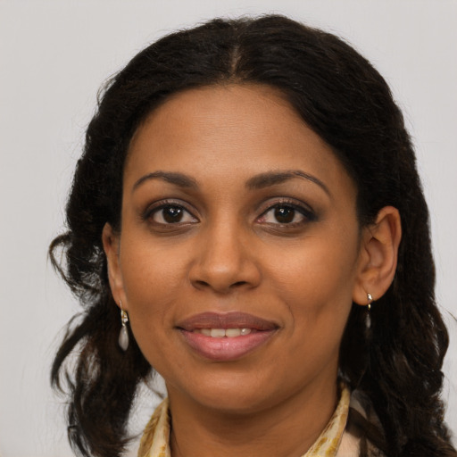 Joyful black young-adult female with medium  brown hair and brown eyes