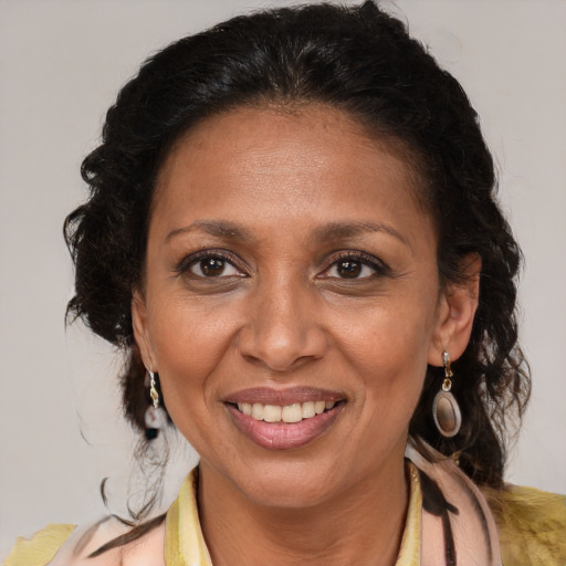 Joyful latino adult female with medium  brown hair and brown eyes