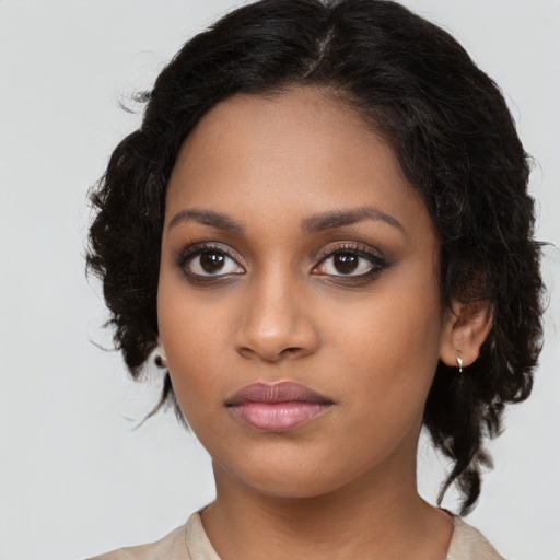 Joyful black young-adult female with long  black hair and brown eyes
